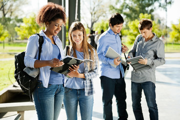 Students Reading Books In University Campus