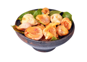 Dried fig in ceramic bowl, isolated on white background