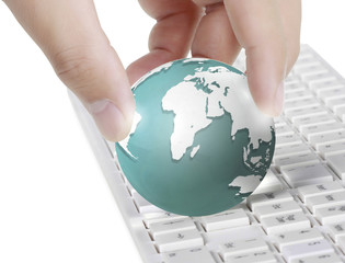 Close up of finger globe  on  keyboard