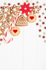 Christmas homemade gingerbread cookies and decoration over white