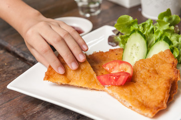 fried shrimp roti  in women's hand