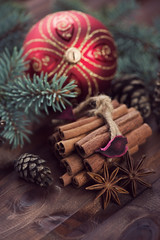 Christmas time: spices, fir-tree branches and xmas ball