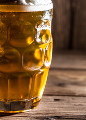 Mug of beer on wooden background