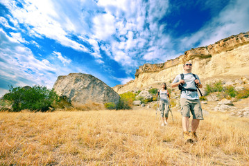 Fototapeta na wymiar Adult man and woman are hiking