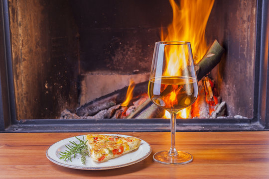 snacks and wine at cozy fireplace