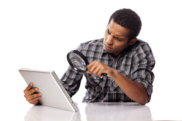 african man carefully looking on the back side on his laptop