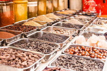 Jars of herbs and powders in a indian spice shop.