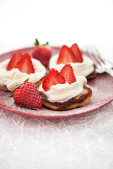 Pancakes with whipped cream and strawberry