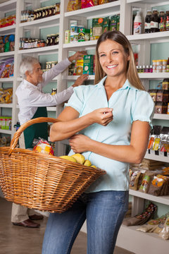 Happy Woman Holding Shopping Basket