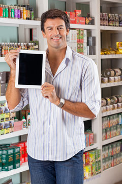 Man Showing Digital Tablet In Supermarket