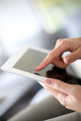 Closeup of hand sliding on digital tablet