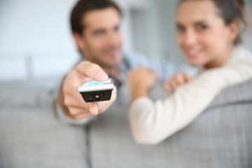 Couple sitting in sofa and watching movie