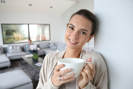 Beautiful woman at home drinking hot tea
