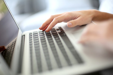Closeup of hand typing on computer desktop