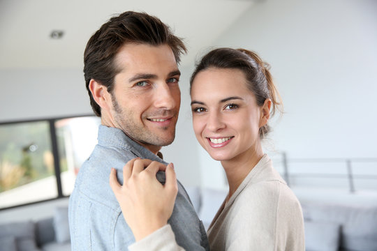 Portrait of smiling couple relaxing at home