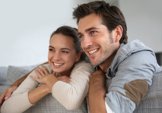 Couple at home relaxing in sofa