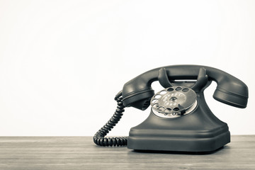 Retro telephone on table with empty place for vintage background