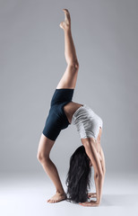 girl doing gymnastic poses in studio