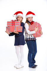 Two girl in Santa's hat with gift box