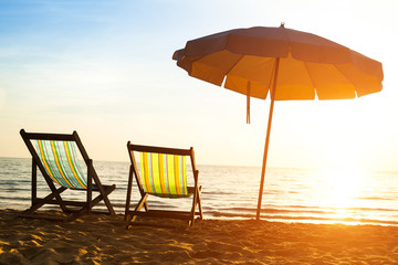 Beach loungers at sunrise