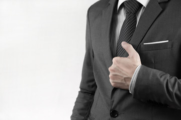 Business man adjusting his necktie