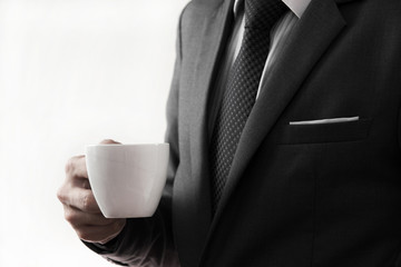 Business man offering cup of coffee.