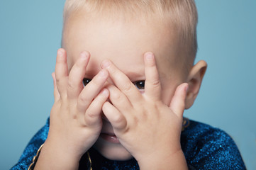 Little funy boy plays hide and seek