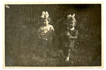 Two little girls in garden - circa 1950