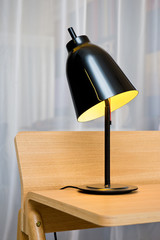 Detail of modern design lamp on a wooden desk