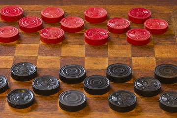 Classic Game of Checkers on an Antique Wooden Board