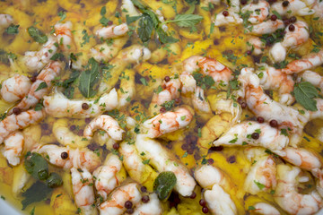 Obraz na płótnie Canvas food background of lots of cooked italian prawns in olive oil