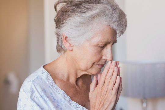 Retired woman praying