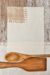 Canvas, burlap and linen fabric with wooden utensils