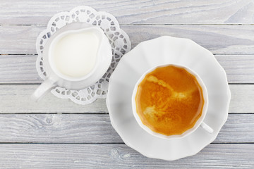 coffee and cream jug on a wooden table