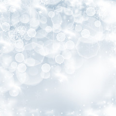 Light blue abstract Christmas background with white snowflakes
