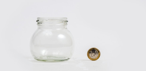 Euro coin by empty jar