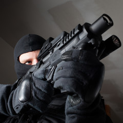Special forces soldier is aiming and shooting on the target