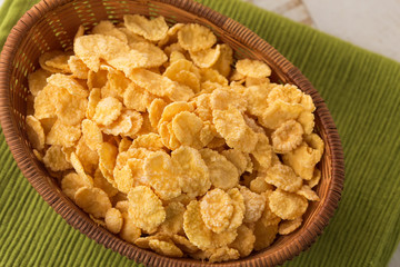 Cornflakes in bowl on table