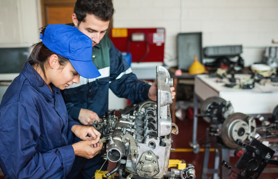 Focused trainee and instructor checking engine