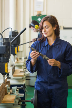 Happy trainee holding tool