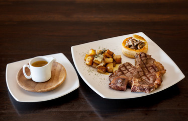 The t - bone steak  grilled on plate.