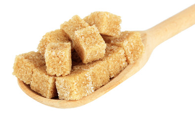Brown sugar in spoon isolated on white