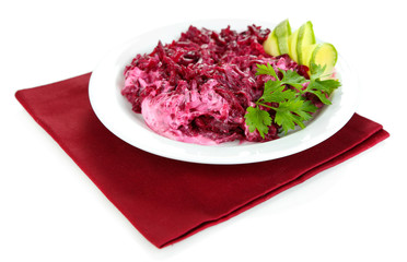 Beet salad on plate on napkin isolated on white