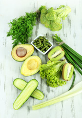 Fresh green vegetables, on wooden background