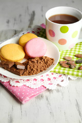 Cocoa in cup with sweets and cocoa powder