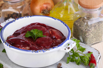 Raw liver in pan with spices and condiments