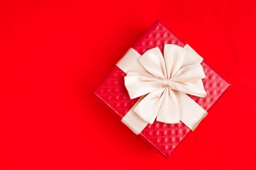Little red gift on red background
