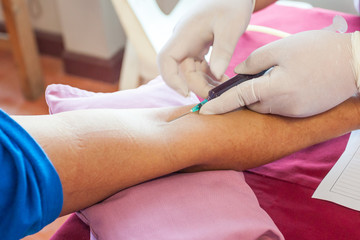close up hand women of blood extraction by Nurse