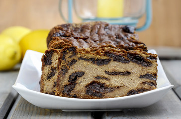 Traditional delicious pate stuffed with plums on wooden table. C