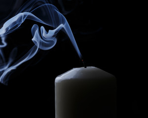 extinguished candle with blue smoke
